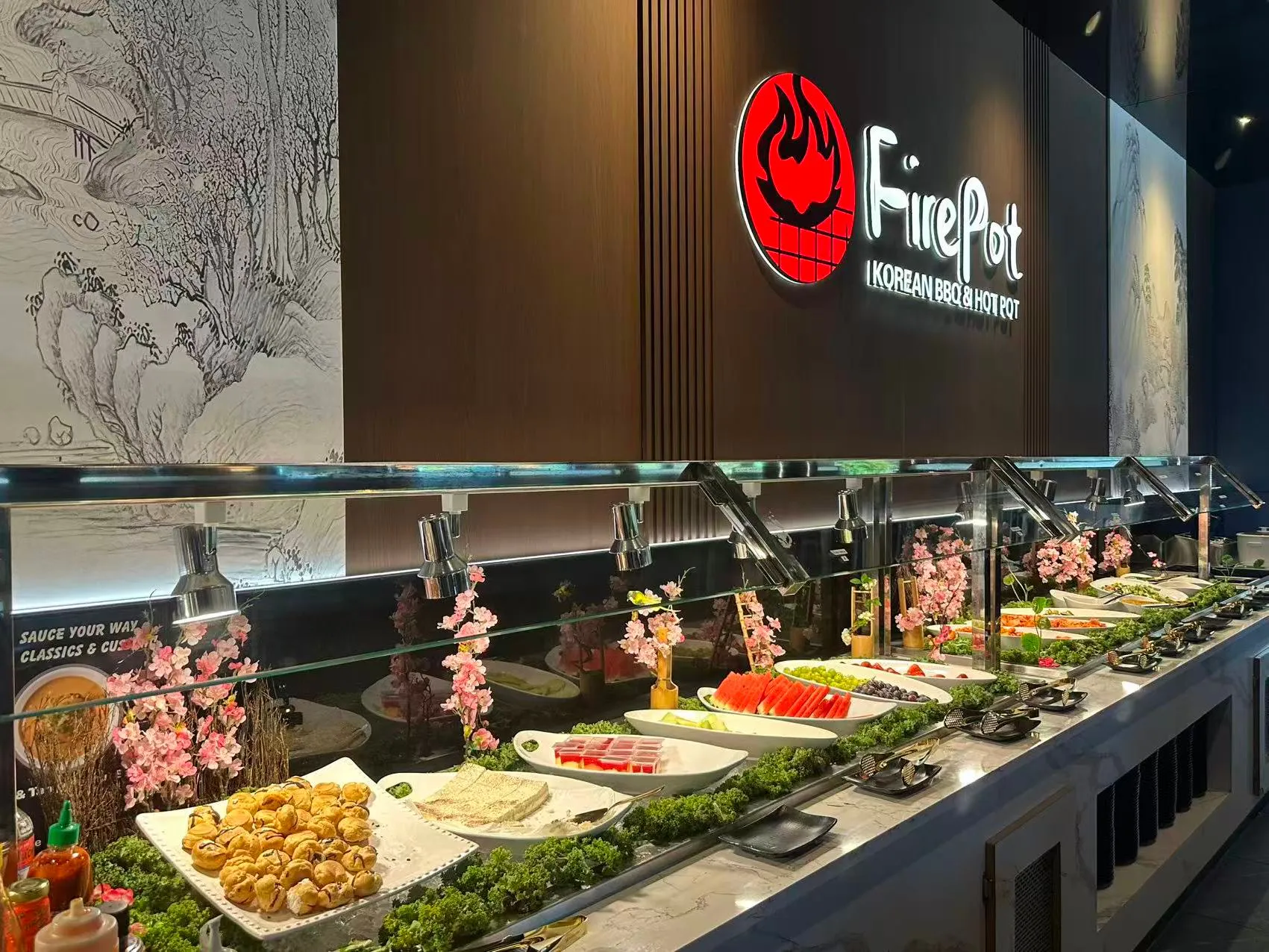 Self-service side dish bar with fruits, snacks and greens at FirePot Korean BBQ & Hot Pot, an Asian Restaurant in Grand Forks