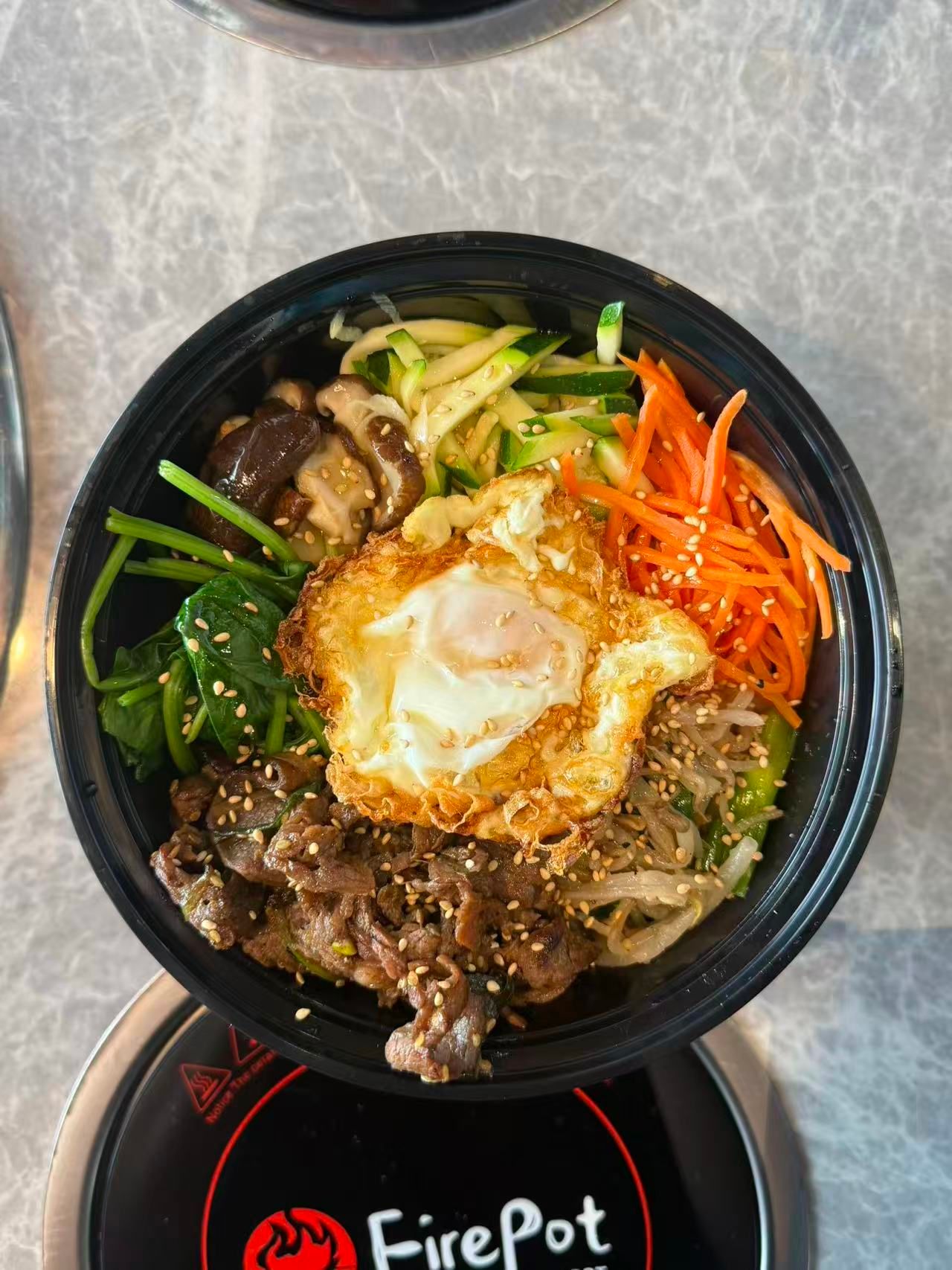 Korean beef bibimbap with assorted vegetables and fried sunny egg at FirePot Korean BBQ & Hot Pot, a Asian Restaurant in Grand Forks