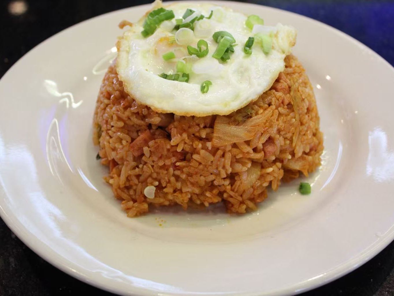 Kimchi fried rice stacked with sunny side up fried egg at FirePot Korean BBQ & Hot Pot, an Asian Restaurant in Grand Forks