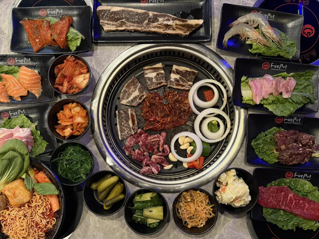 Full spread of BBQ meats, seafood and side dishes at FirePot Korean BBQ & Hot Pot, an Asian Restaurant in Grand Forks